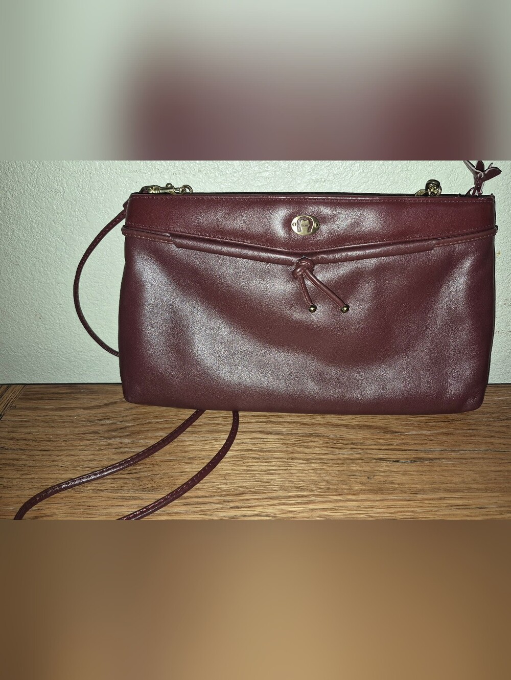 Vintage Etienne Aigner Burgundy leather clutch with a horseshoe logo